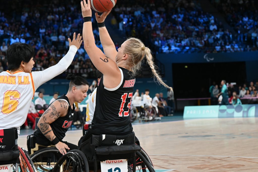 Canadian player going up for a layup against China