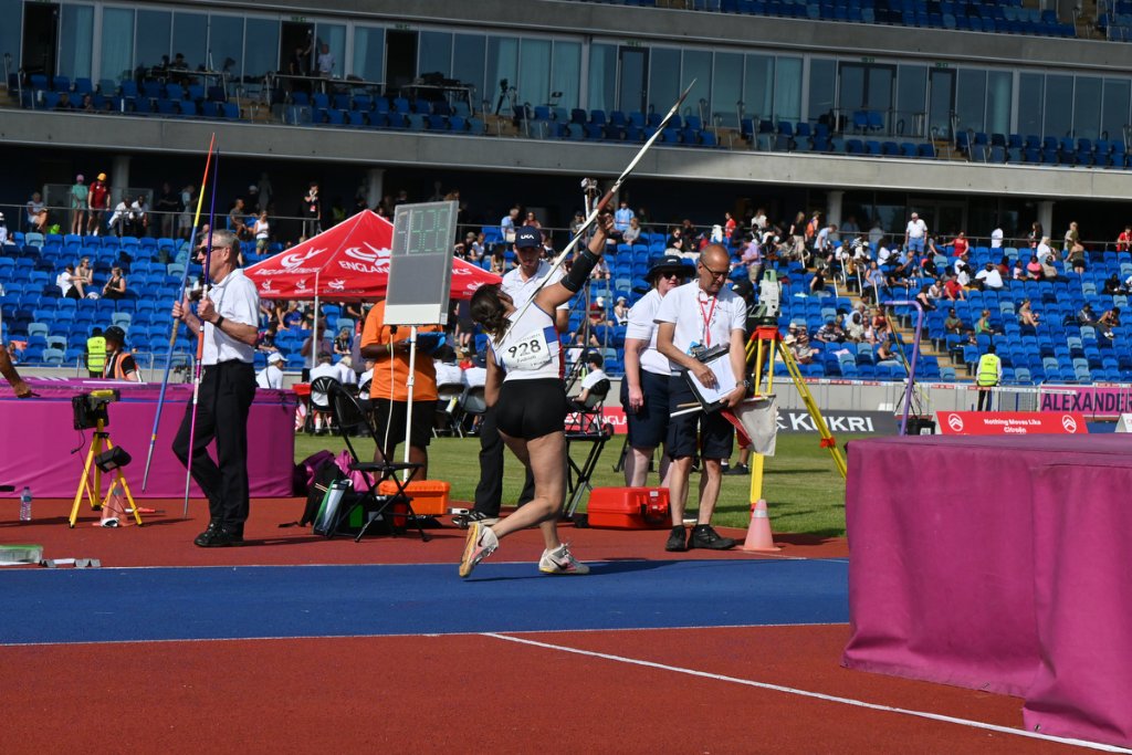 Athletes including a prosthetic leg user preparing in starting blocks