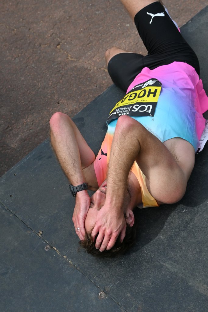 Exhausted marathon runner lying on ground at TCS London Marathon 2026