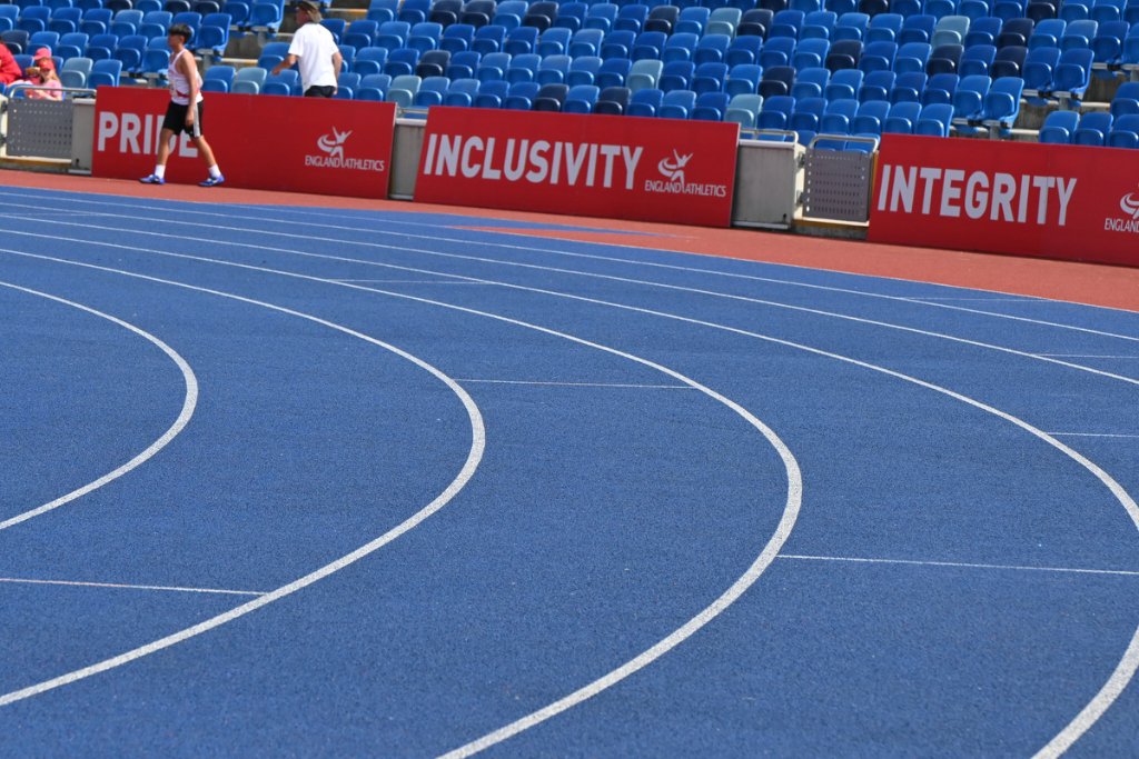 Group of male sprinters racing down the straight at Birmingham