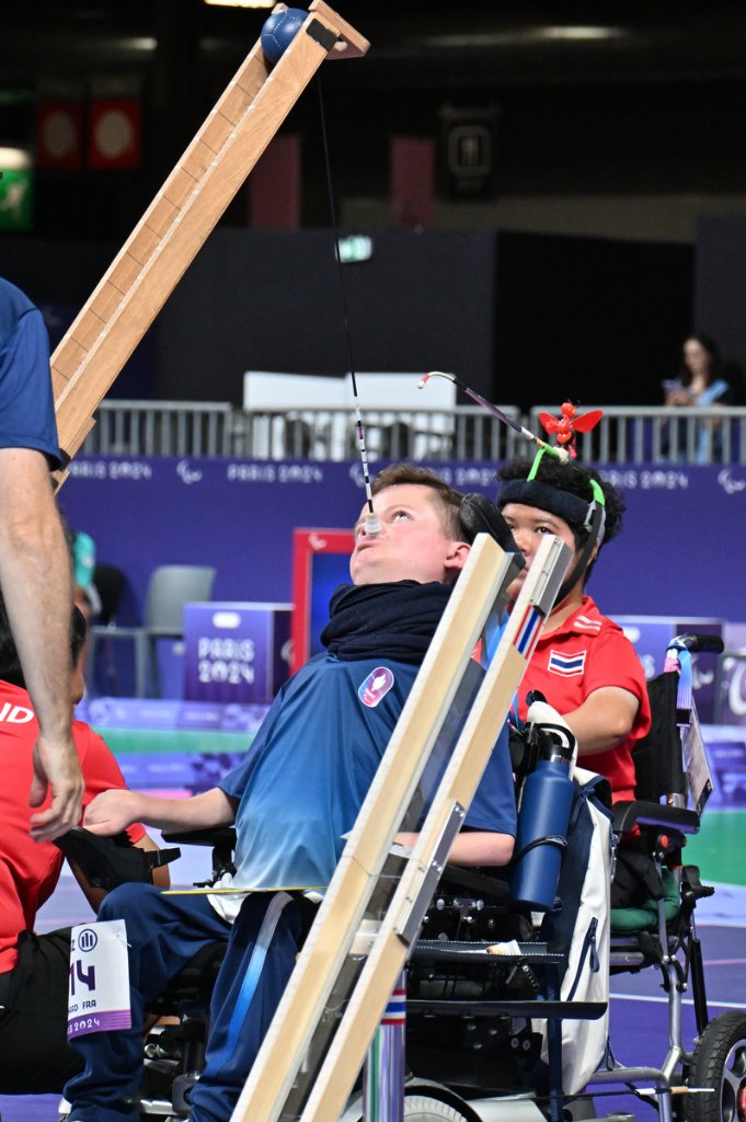 Two young BC3 Boccia athletes watching the ball arc off the ramp at Paris 2024