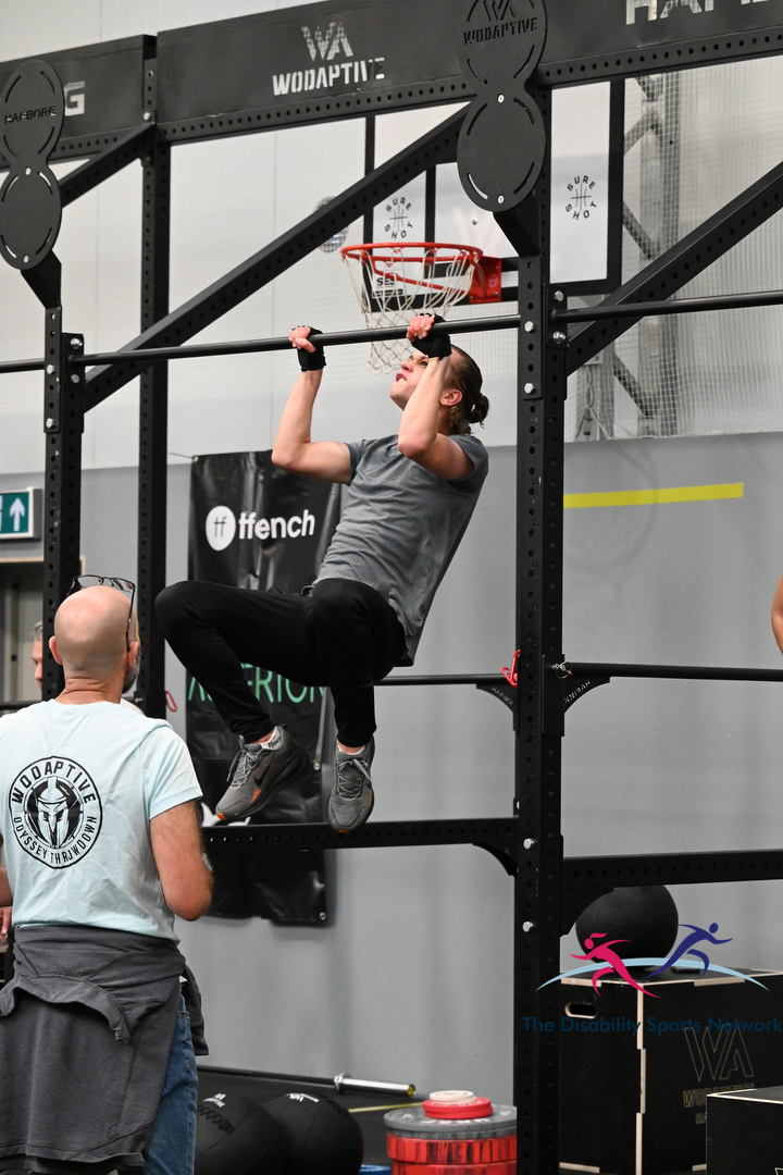 Athlete completing a pull-up on the gym rig at Alt Movement