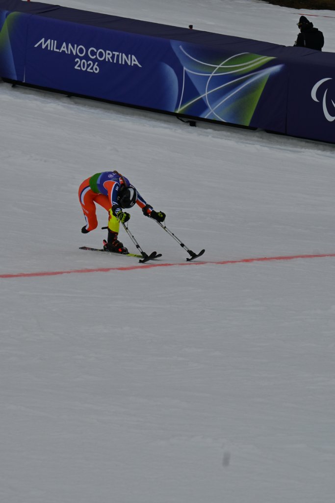 International crowd waving flags at the alpine skiing venue at Milano Cortina 2026 Winter Paralympics