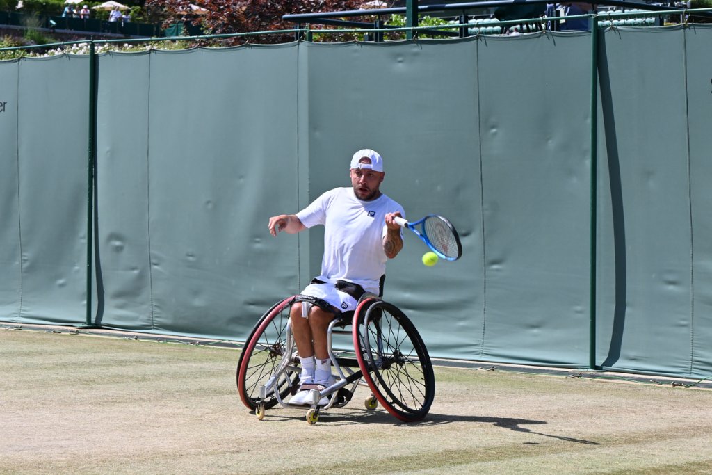 Wheelchair tennis player hitting a forehand at Wimbledon 2025