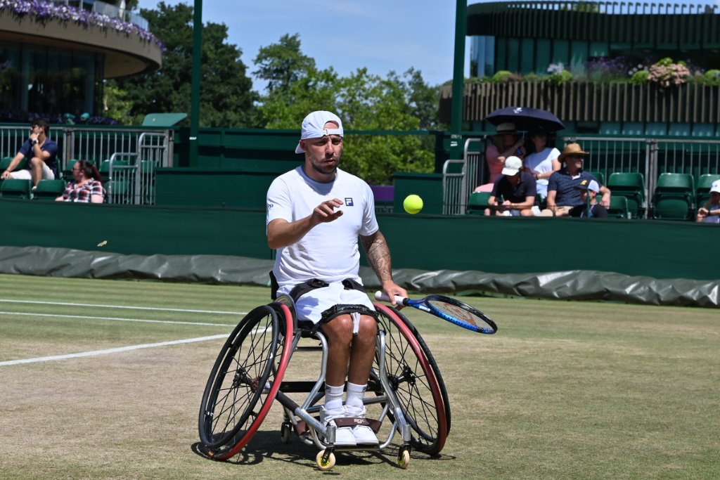 Wheelchair tennis player preparing to serve at Wimbledon