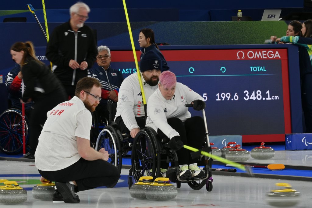 Great Britain wheelchair curling team delivering a stone at Milano Cortina 2026 Winter Paralympics