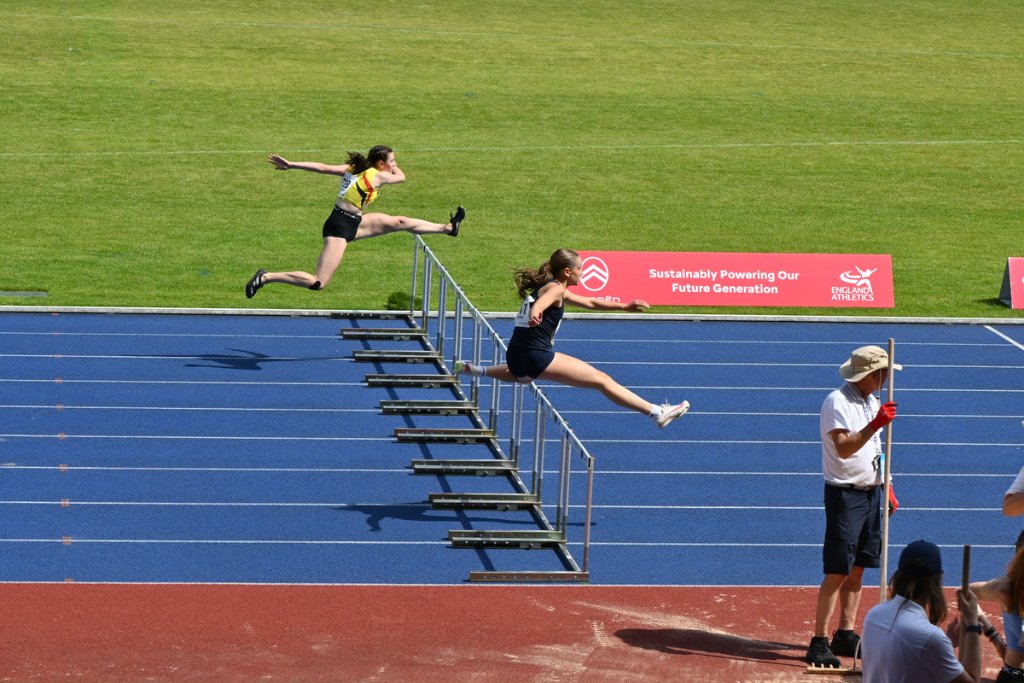 Empty blue running track with England Athletics branding at Birmingham