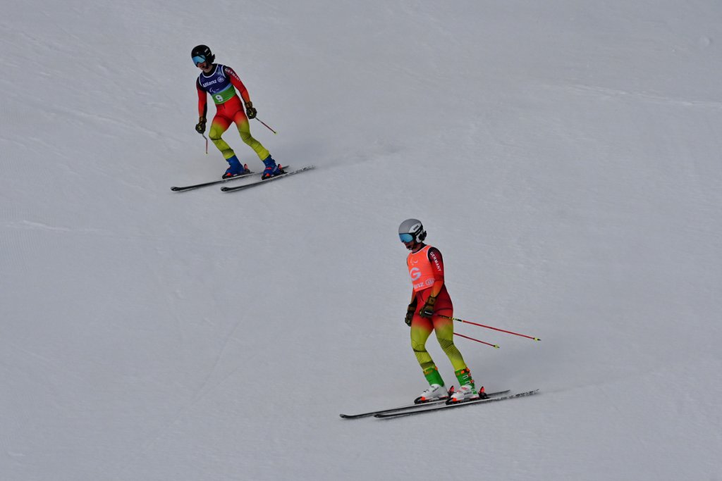 Two para alpine skiers on the slope at Milano Cortina 2026 Winter Paralympics