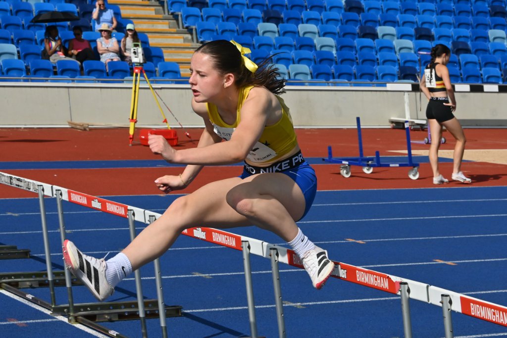 Female para athlete with prosthetic running blade walking on the track