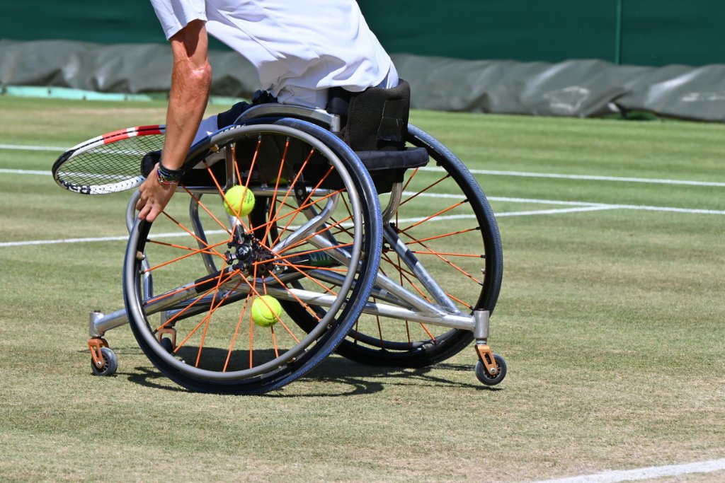 Detail of wheelchair tennis chair wheel with tennis balls in the spokes