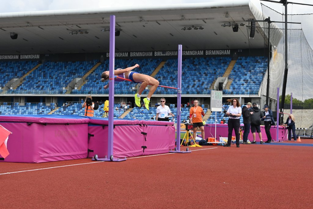 Female high jumper arching over the bar at Birmingham stadium