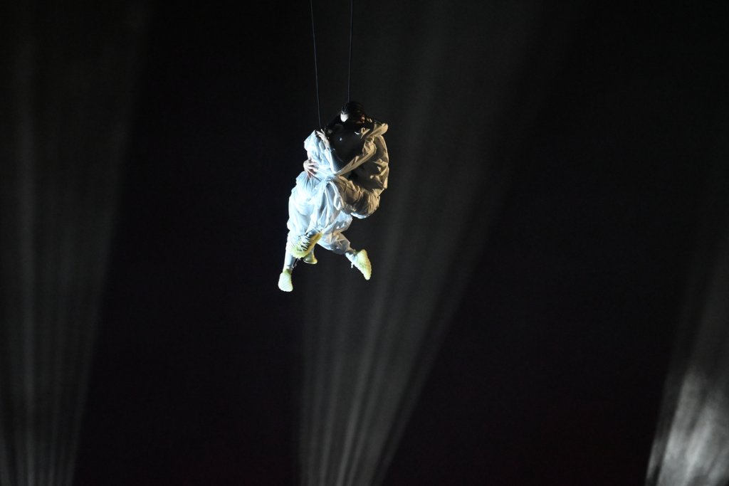Two aerial performers suspended by wires at the 2026 Winter Paralympics Opening Ceremony