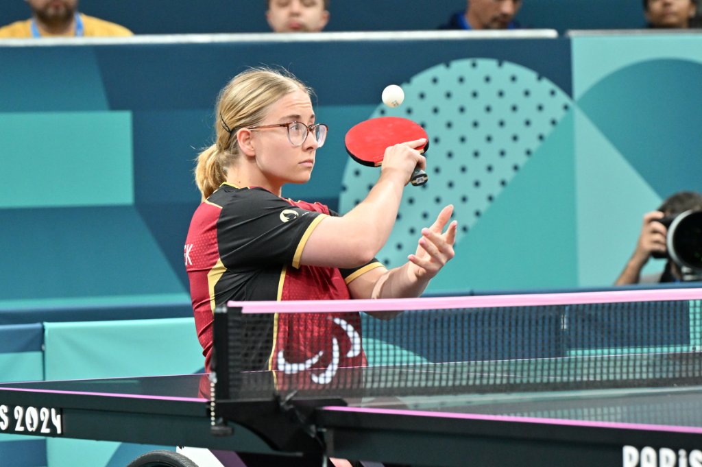 German wheelchair para table tennis player tossing ball for serve, Paris 2024
