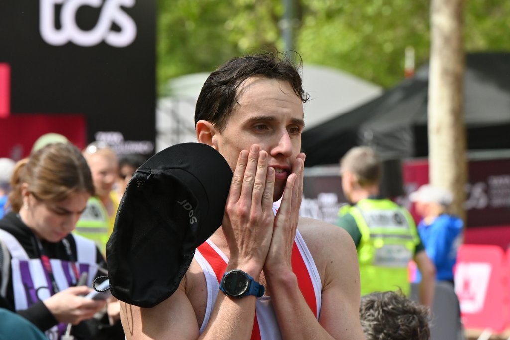 Runner covering face in emotion at the finish of TCS London Marathon 2026