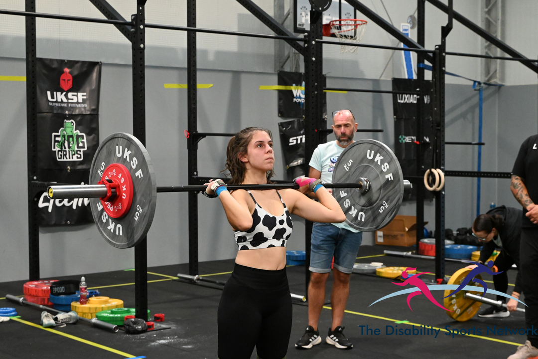Athlete performing a barbell clean and jerk during the Alt Movement competition