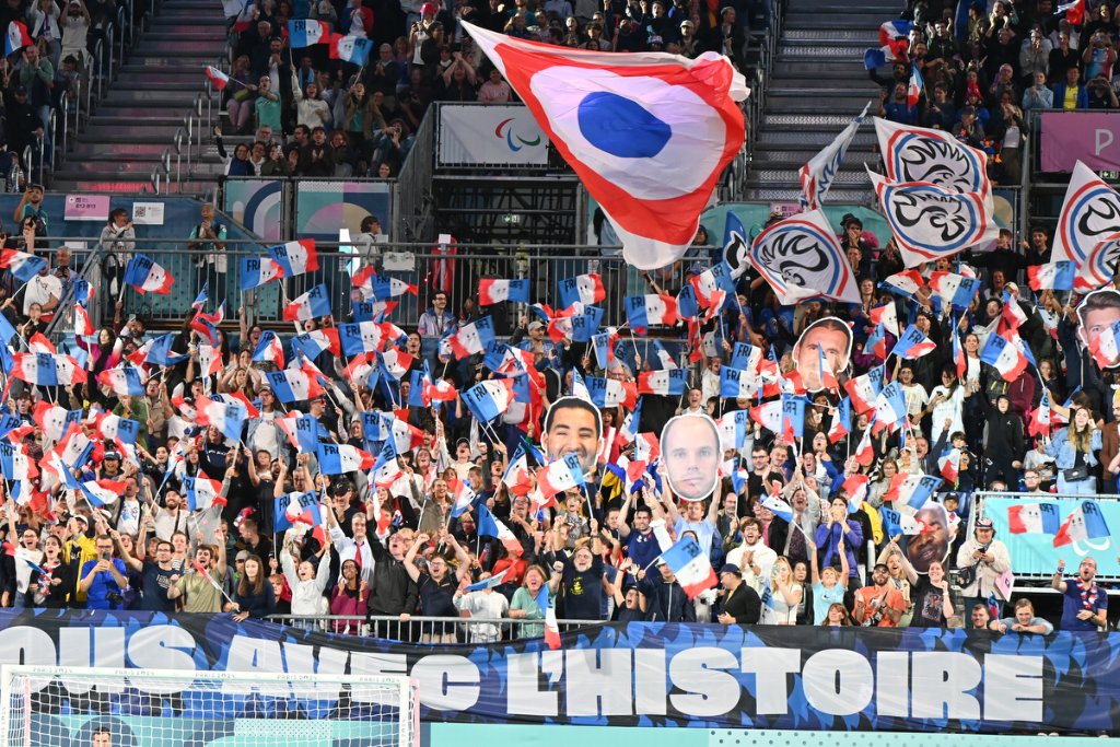 French fans waving flags at the blind football gold medal match at Paris 2024 Paralympics
