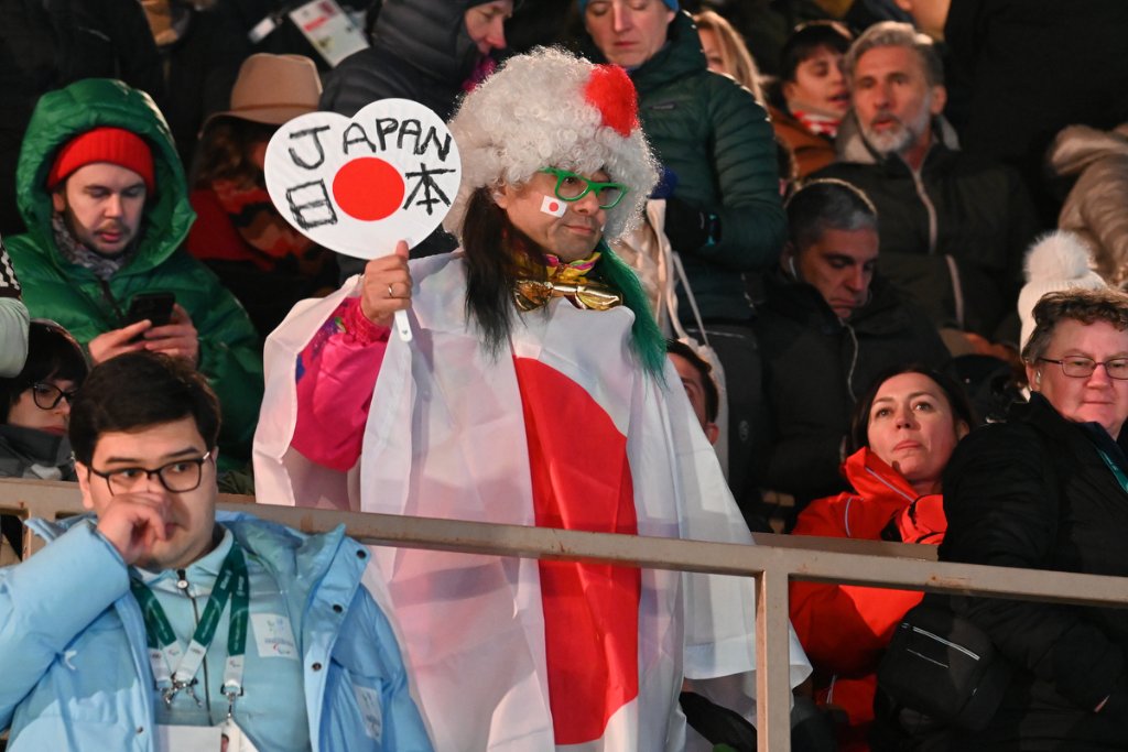 Japanese fan wrapped in flag at the 2026 Winter Paralympics Opening Ceremony