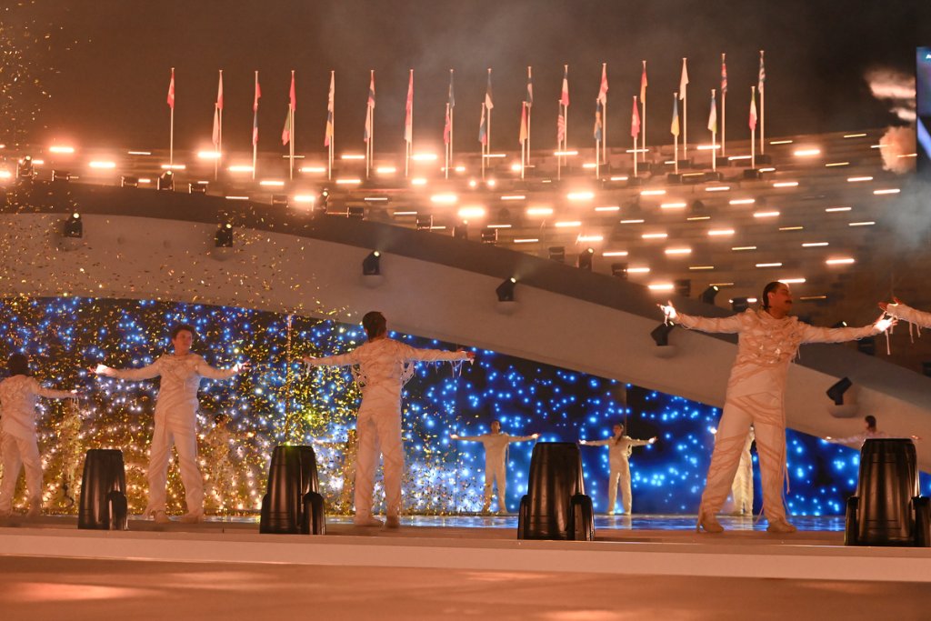 Grand stage show with performers in white at the 2026 Winter Paralympics Opening Ceremony