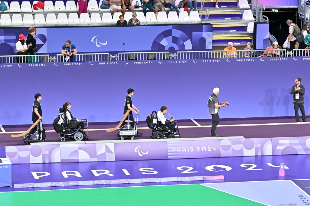 Boccia team entering the court in power wheelchairs at Paris 2024
