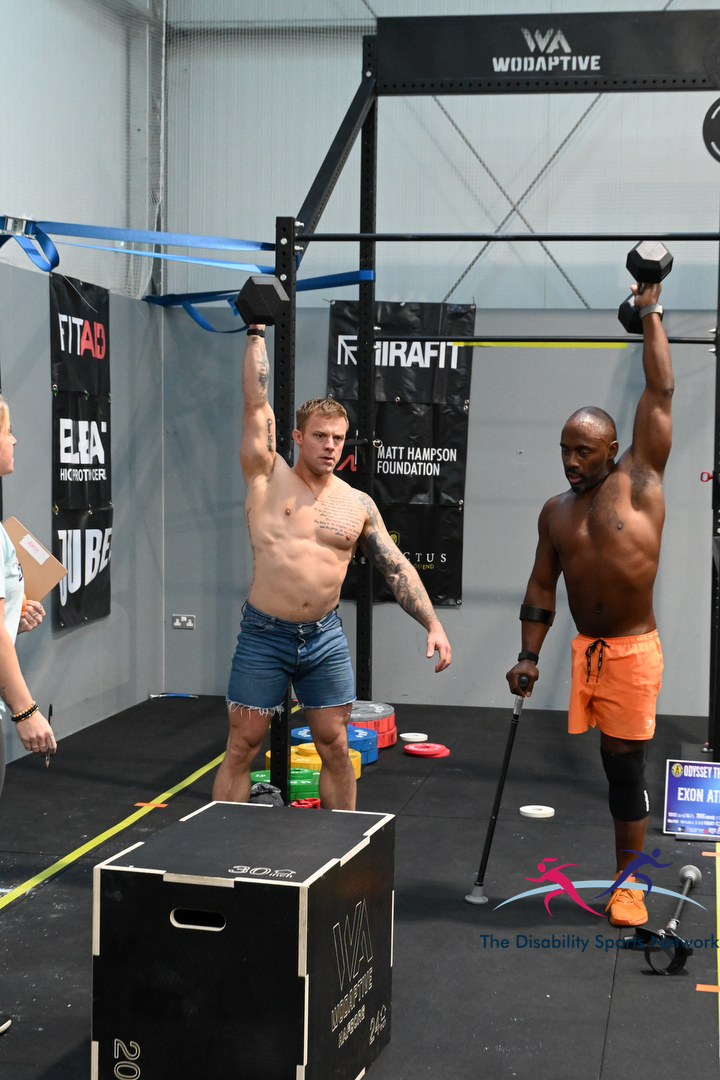 Two athletes performing single-arm dumbbell overhead presses at Alt Movement