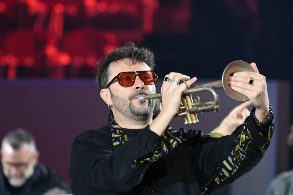 Trumpeter with red sunglasses performing at the 2026 Winter Paralympics Opening Ceremony