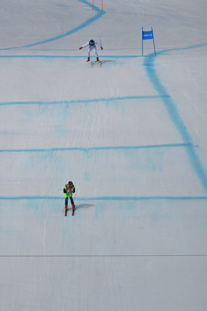 Two para alpine skiers celebrating on the snow at Milano Cortina 2026 Winter Paralympics