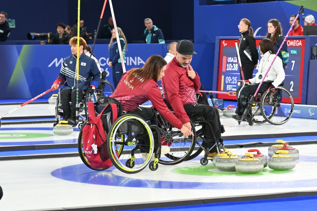 Wheelchair curler delivering stone at the 2026 Winter Paralympics