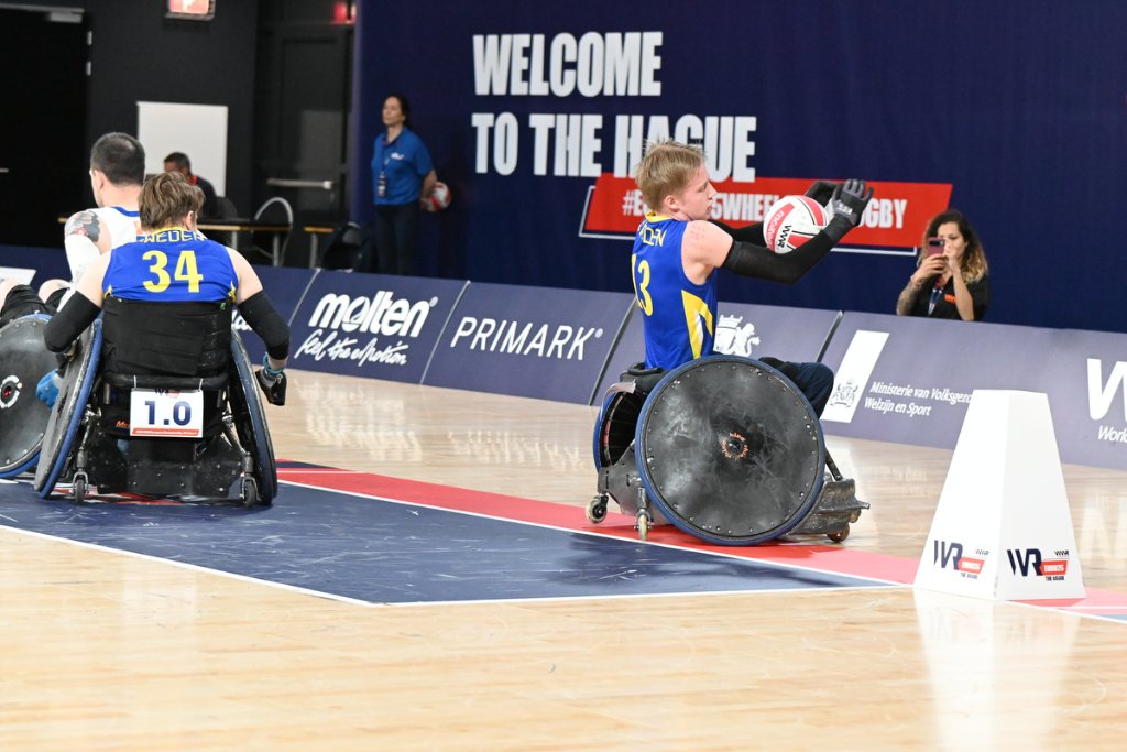 Swedish player No.13 reaching out with ball at the try line