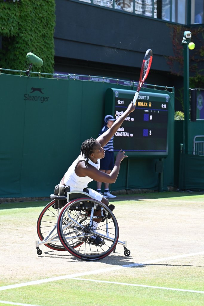 Women's wheelchair tennis player serving on Court 17 at Wimbledon 2025