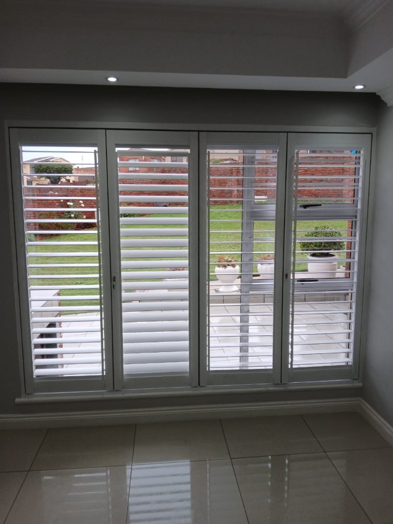 White security shutters fitted across large patio doors by EasyBlinds Cape Town custom window blinds specialists