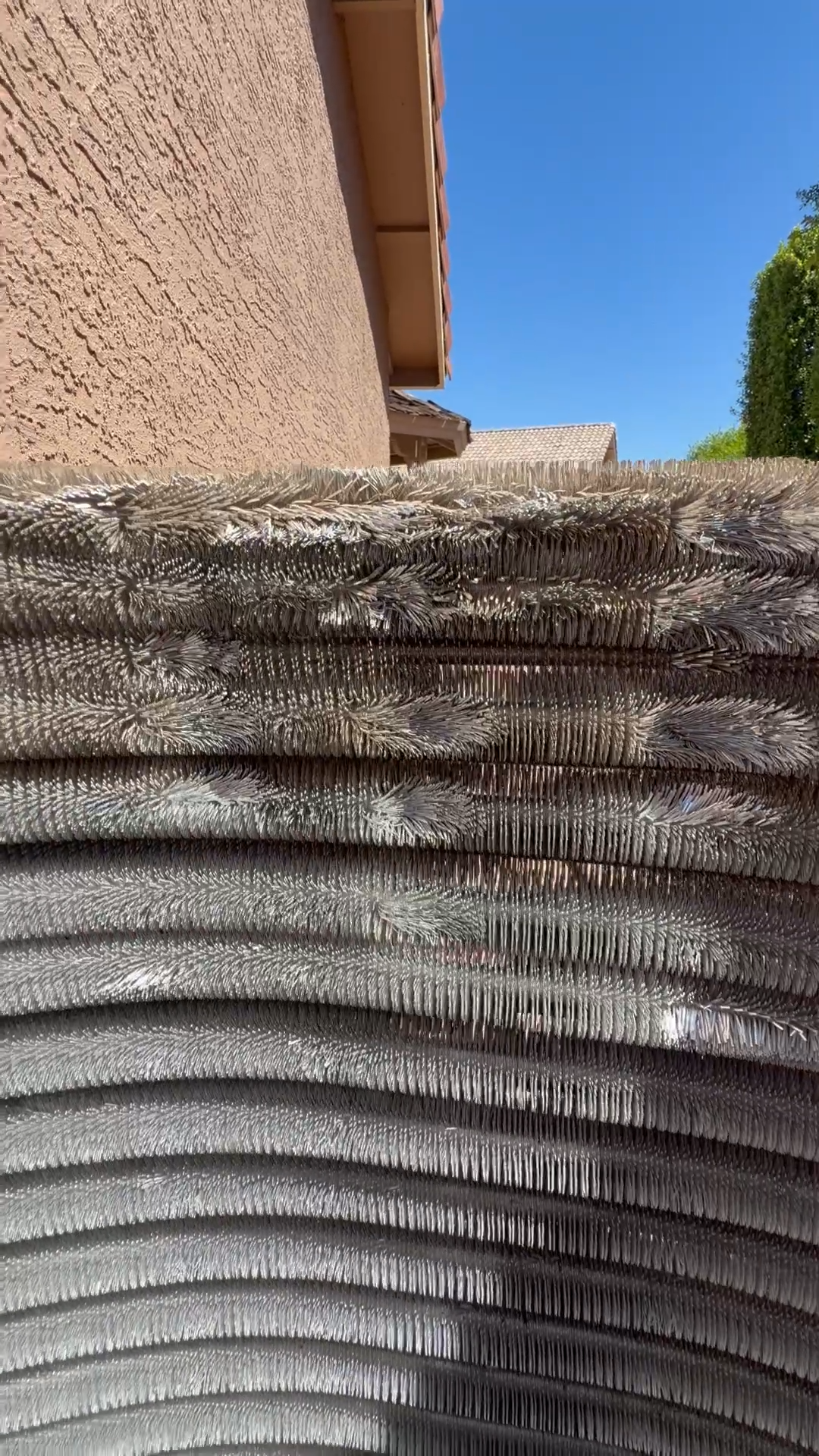 HVAC condenser coil close-up with Ahwatukee home