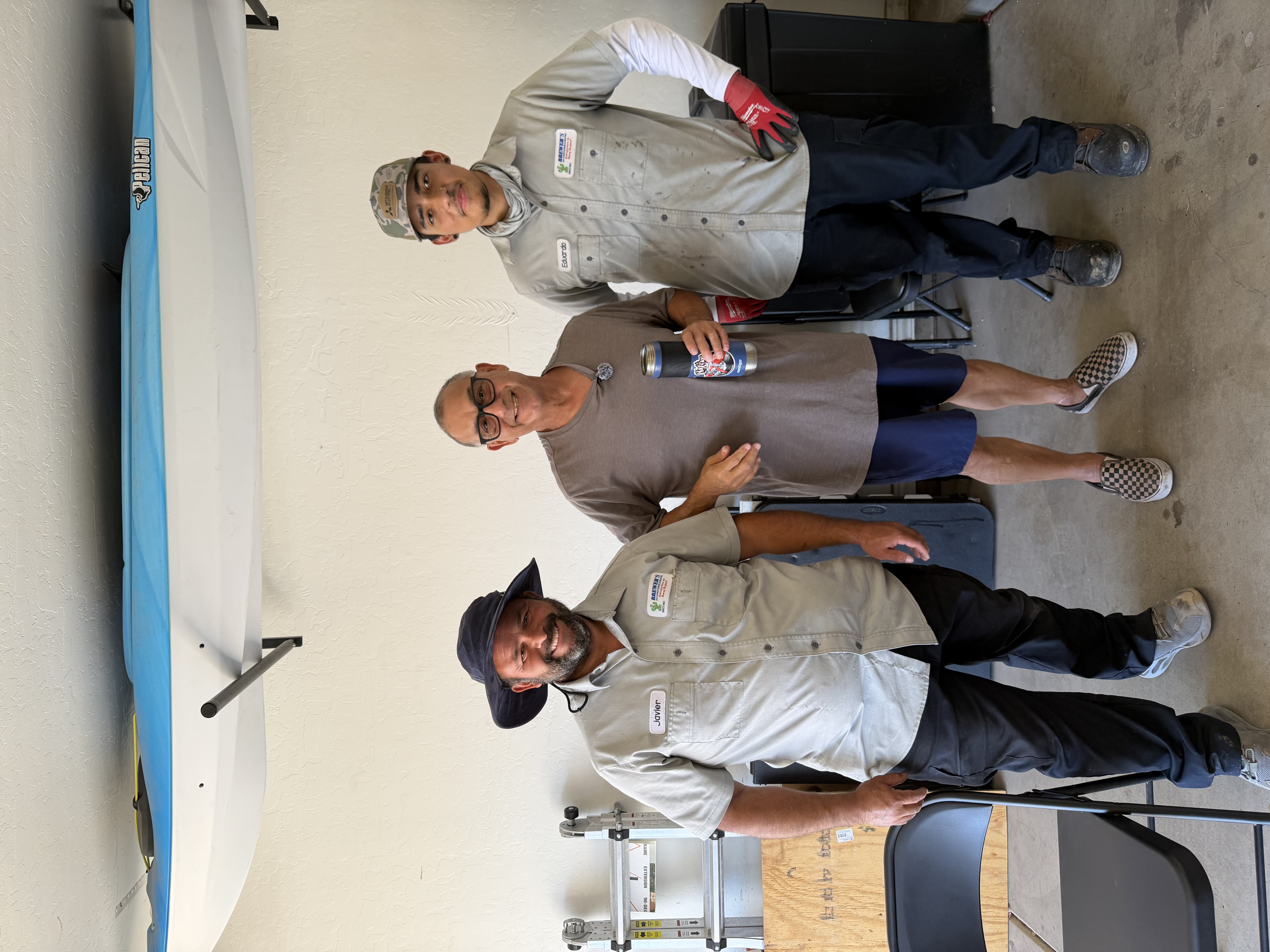 Brewer's technicians Javier and Eduardo with a happy homeowner