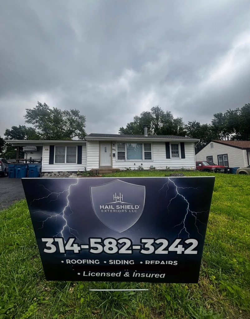 Hail Shield Exteriors yard sign in front of completed residential roofing project