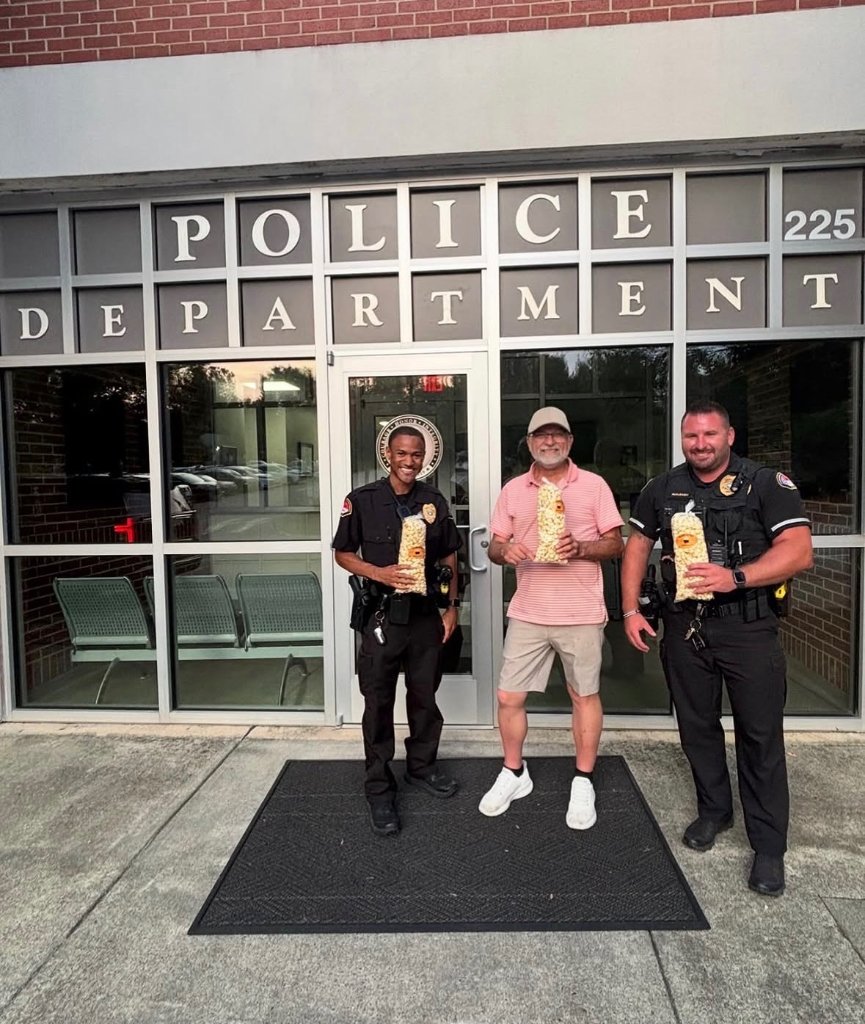 Blazing Kettle donating popcorn to the police department.