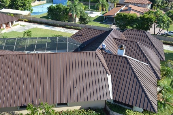 Aerial drone view of dark brown standing seam metal roof replacement on a large South Florida home