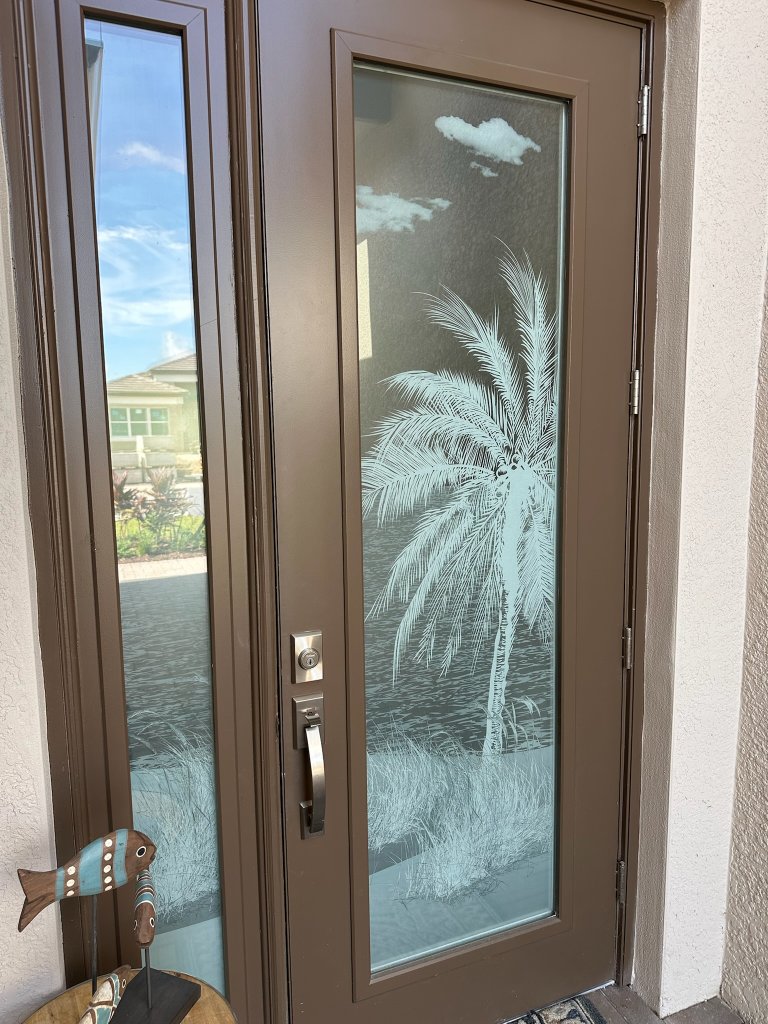 Palm design on an open wood-framed entry door