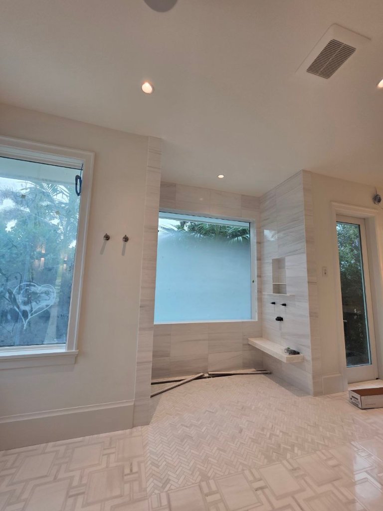 Frosted privacy treatments across bathroom windows