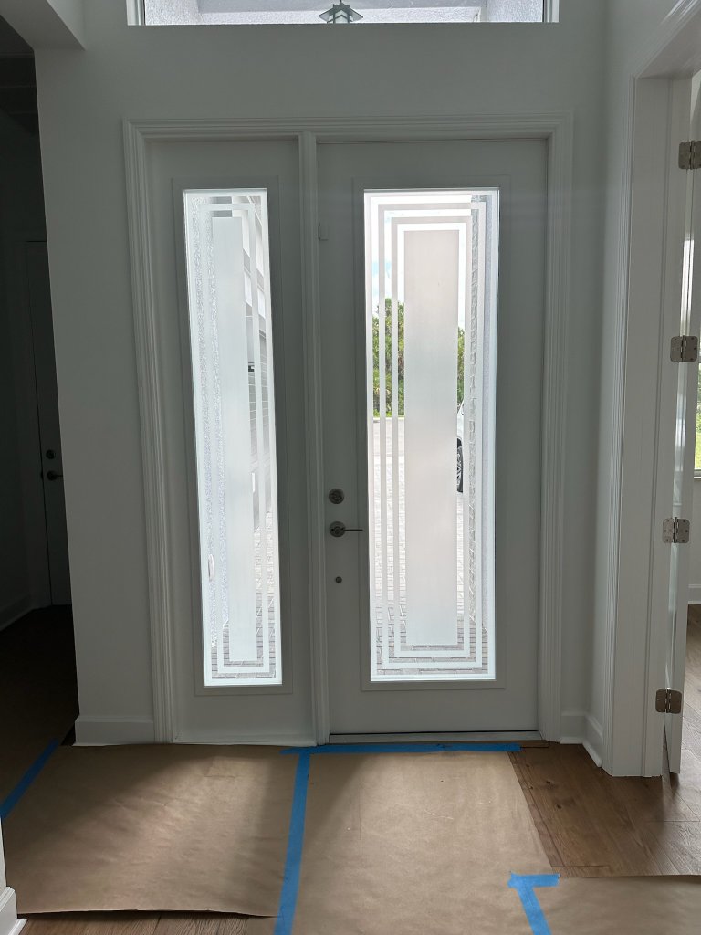 Rectangular clear borders on white double entry doors