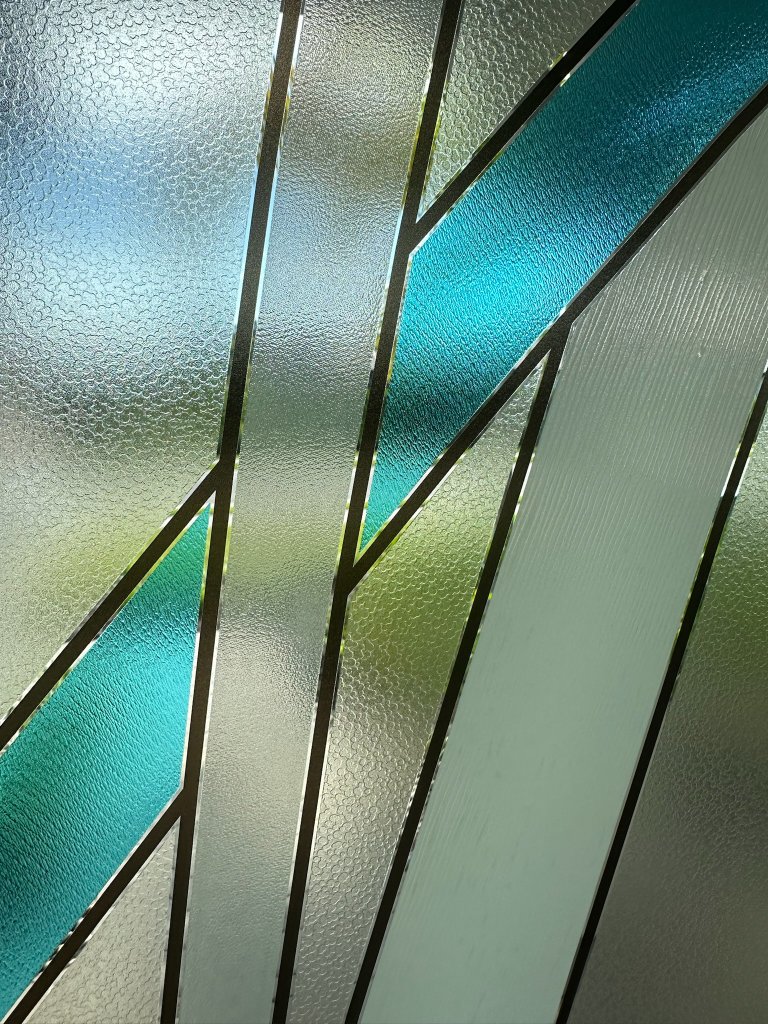 Close-up of blue color and black line accents in textured film