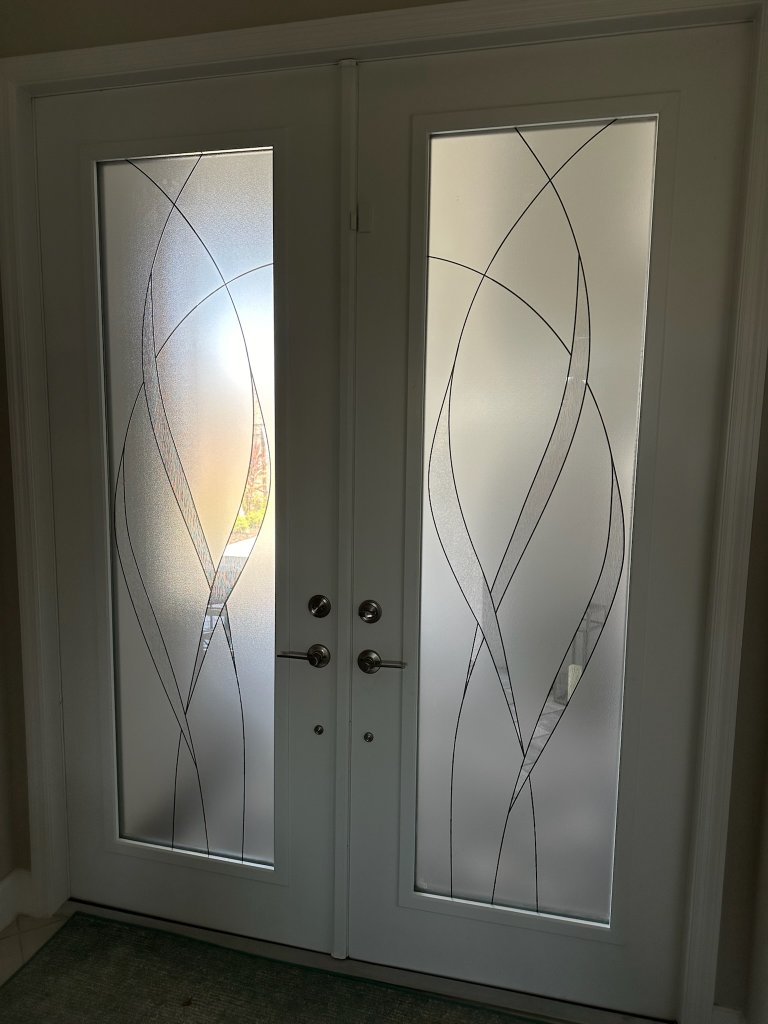 Curved decorative linework on white double entry doors