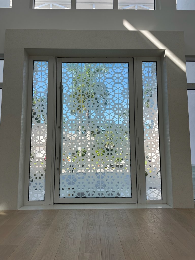 Decorative mosaic pattern across an entry door and sidelights