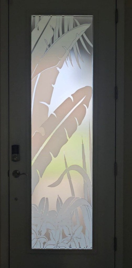 Close-up of tropical bird and foliage artwork on glass