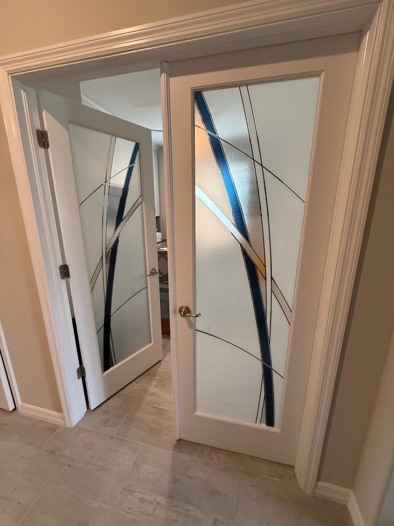 Sweeping dark accents on frosted double entry doors