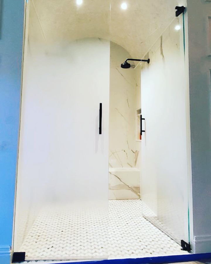 Frosted privacy treatment on a walk-in shower door