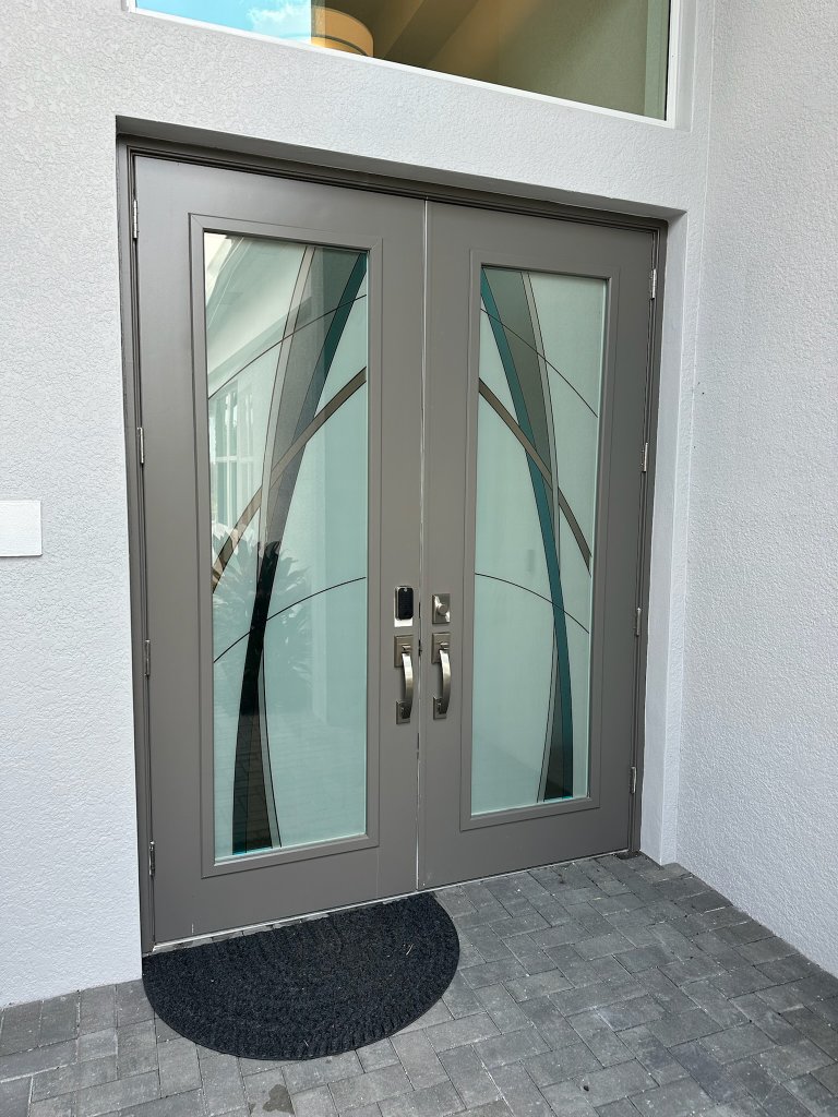 Bold sweeping curves on frosted double entry doors