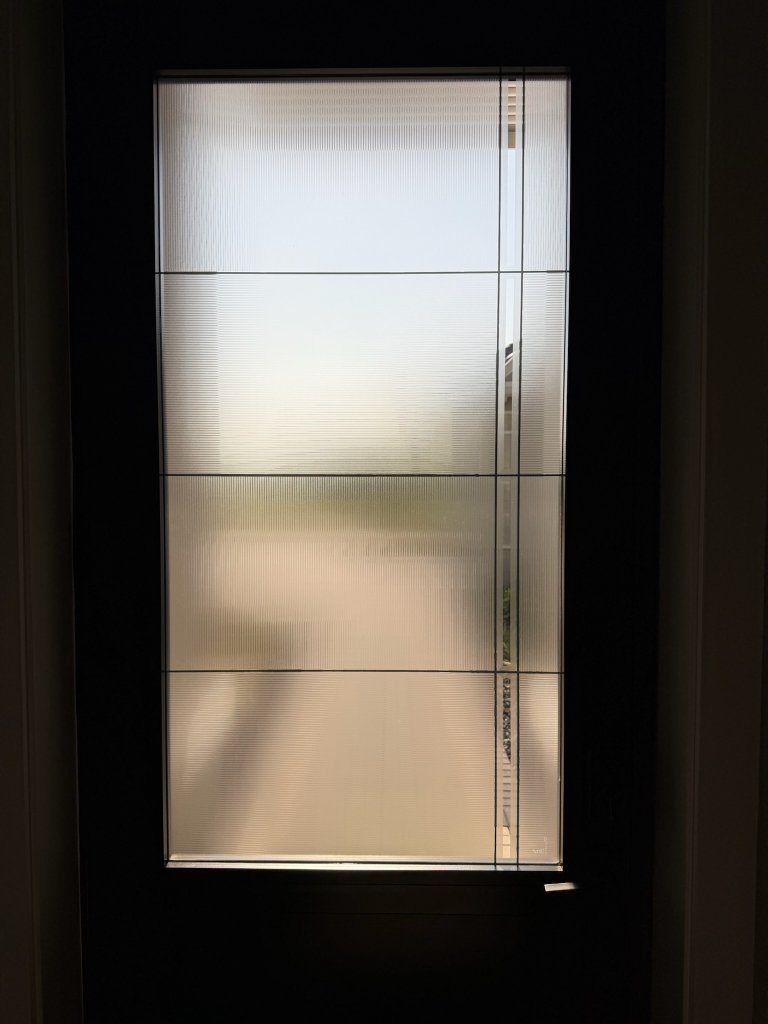 Rectangular line accents on a frosted entry-door pane