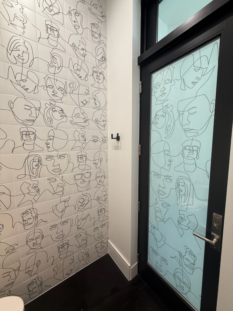 Floral decorative film next to patterned bathroom wallcovering