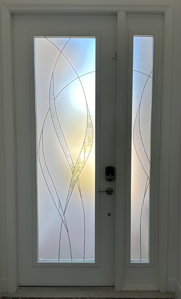 Fine curved linework on a single entry door and sidelight