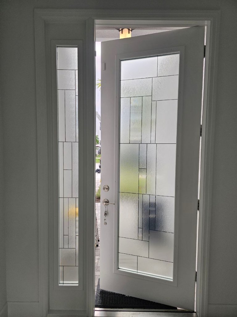 Rectangular decorative linework on an open entry door