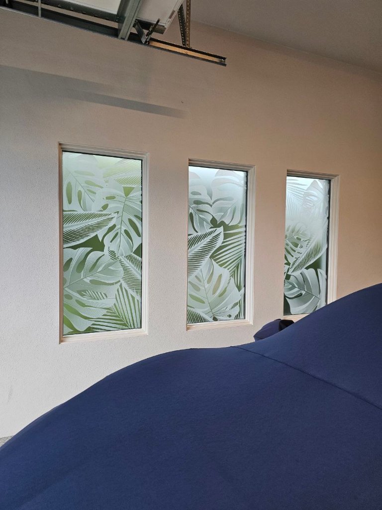 Botanical artwork across three bedroom windows